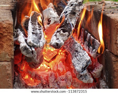 Burning down fire. The heated coals. A bright beautiful flame.