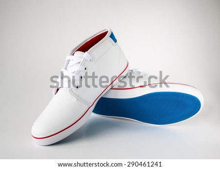 pair of white casual leather shoe with blue sole