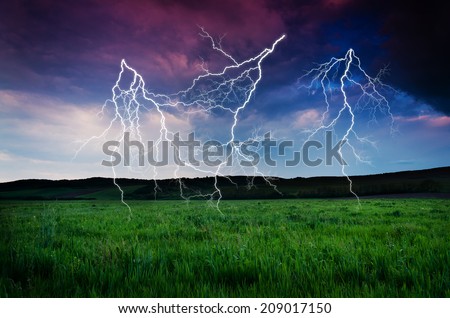 Thunderstorm with lightning in green meadow