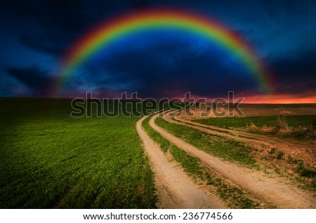 Dirt road and rainbow in the night.