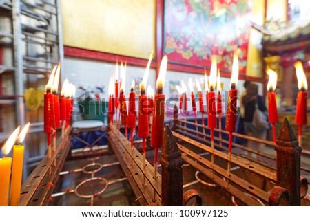 BANGKOK - JANUARY 22: Candles inside chinese temple during the Chinese New Year celebrations on January 22, 2012 in Bangkok, Thailand.