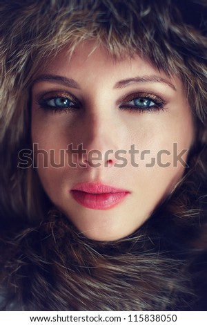 Woman face close-up in fur, fashion portrait.