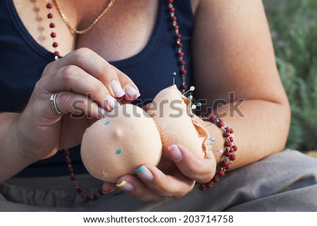 Doll making process\
A woman sews a doll head