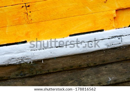 A close up view of the paint on a wooden boat