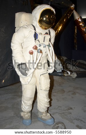 A  space man on the moon with lander behind