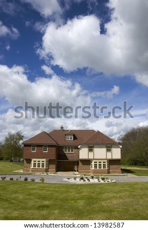 A big detached home with a cloudy sky