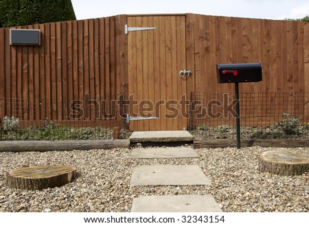 A new wooden fence with a path leading to the gate