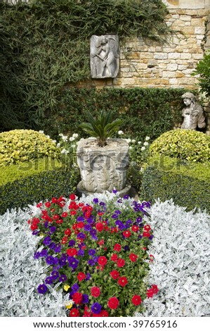 A wall garden with a statue in the background