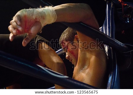 CHIANGMAI, THAILAND - JANUARY 2 : Oung Siya resting in corner between rounds and receives  trainer\'s advice in Ancient Thai boxing match at Mueng-kaen Fight on January 2, 2013 in Chiangmai, Thailand.