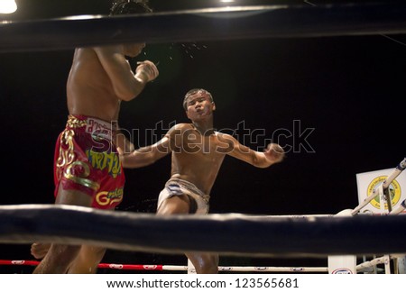 CHIANGMAI, THAILAND - JANUARY 2 : Petsamut Niyomsuk (L) and Oung Siya compete in a Ancient Thai boxing match at Mueng-kaen Fight on January 2, 2013 in Mae Tang district Chiangmai, Thailand.