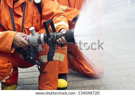 Firefighters spray water