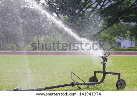 sprinkler head watering the grass