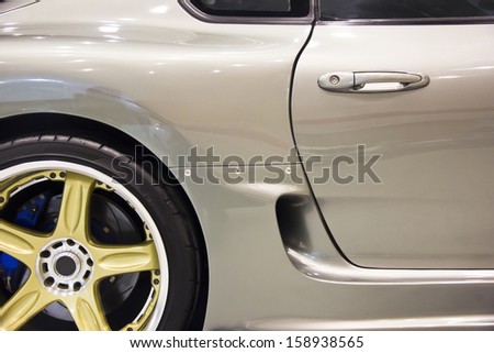 Silver handle on the door of sports car