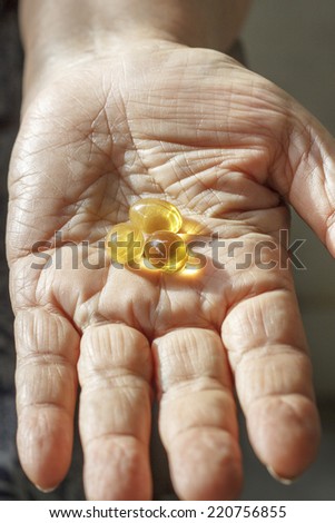 Close-up of elderly hand with supplement