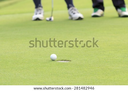 Golf ball on the edge of hole