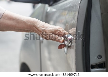 senior woman open car door