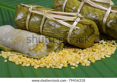 Rice and beans steamed in banana leaf