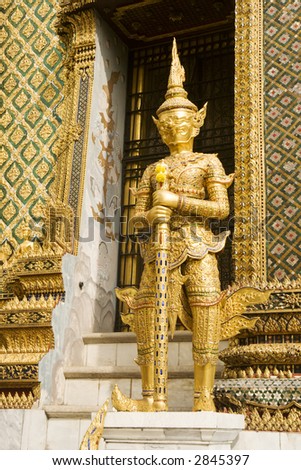 A statue of a demon guardian at the Buddhist temple of Wat Phra Kaeo at the Grand Palance in Bangkok, Thailand.