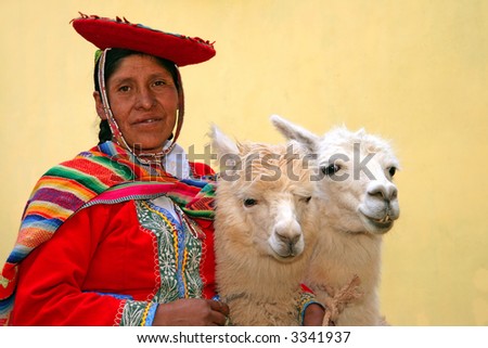 Peruvian lady in authentic dress with two lamas in Cusco, Peru.