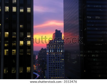 Colorful urban sunset in New York City with modern buildings.