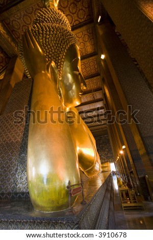 Reclining Buddha at Wat Pho in Bangkok, Thailand.  Largest reclining Buddha in the world.