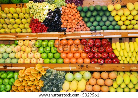 Variety of fruits and vegetables at fruit stand at Thai weekend market.