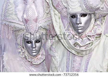 VENICE - MARCH 5: Two unidentified people in costume in St. Mark\'s Square during the Carnival of Venice on March 5, 2011.  The 2011 carnival was held from February 26th to March 8th.