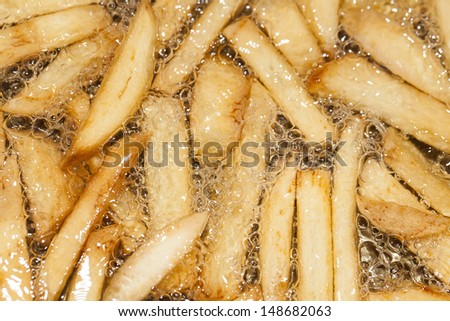 French fries frying in hot oil