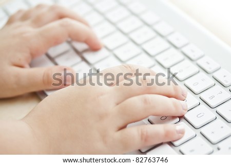 Hands of child on computer keyboard.\
See my portfolio for more