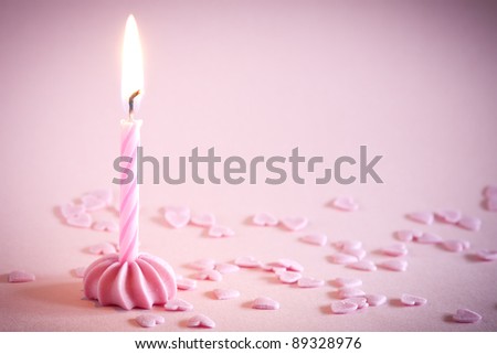 One candle on pink background with space for your text.\
See my portfolio for more