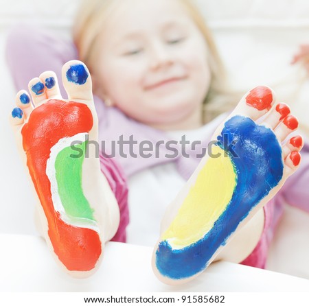 Five year old girl with feet painted.  with focus on feet