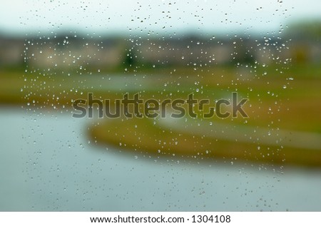 Golf course in the rain. This image has less rain drops but more blurred background.  Can also be a nice background image. This is a photo from A Raining Day Collection. Search keyword Series005.