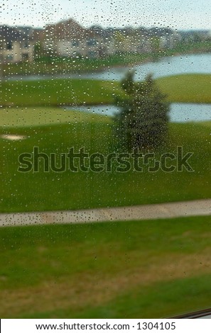 Golf course in the rain. This image has more rain drops but more clear background view. Can also be a nice background image. This is a photo from A Raining Day Collection. Search keyword Series005