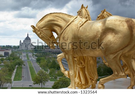 Several gold horses rise above the city skyline. More with keyword Series002.