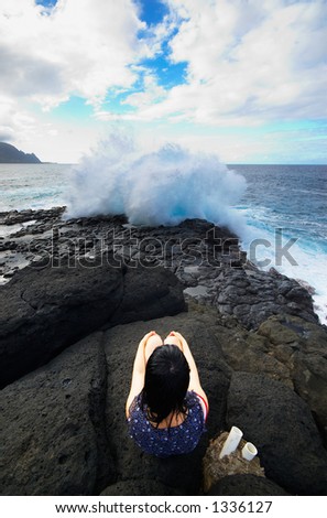 Girl facing huge wave on Kauai Hawaii. More with keyword Series001C.