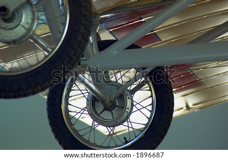 The rear wheels of a vintage biplane. More with keyword Series007