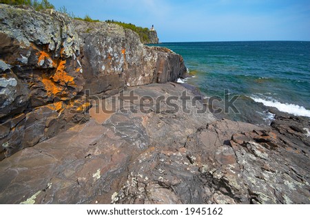 Golden rock wall under Split Rock Light House on Lake Superior. More with keyword Series14