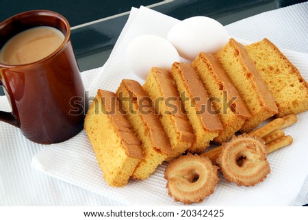 cake, biscuit and  tea with milk