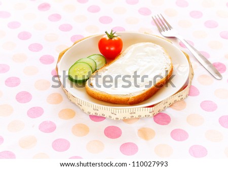 Healthy food for diet as bread  and vegetables with measurement tape
