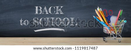 Banner of Shopping cart with school supply in front of blackboard. Back to school concept