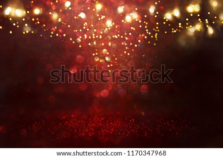 Red, black and gold glitter vintage lights background. defocused