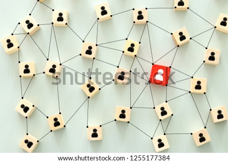 image of wooden blocks with people icons over mint table,building a strong team, human resources and management concept