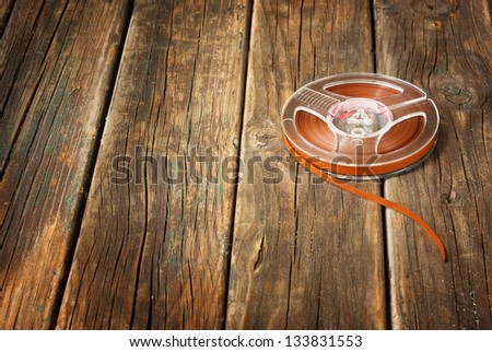 vintage magnetic audio reel  on wooden table. music concept background.