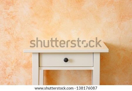 classic empty drawer near terracotta textured wall. room for copy space.