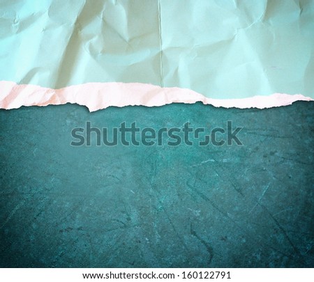 blue torn paper over blue grunge background