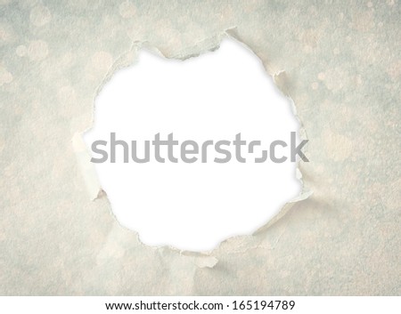 Breakthrough paper hole made from textured paper and circles pattern.