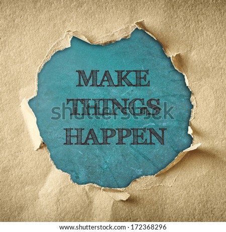 the phrase make things happen written through torn paper hole over chalkboard