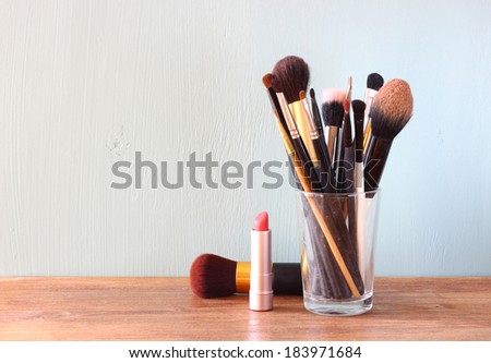 make up brushes over wooden table