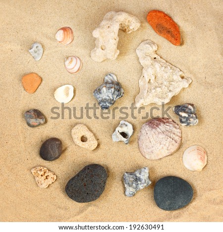 top view of collection of beach stones rock and shells over sand