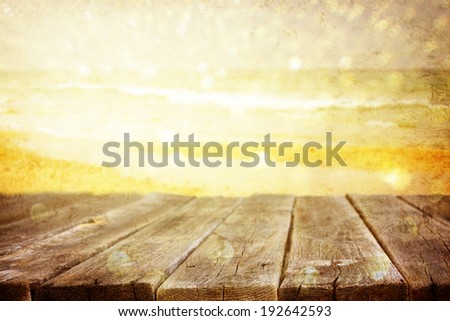 wood planks in front of sea landscape. lens flare. filtered image